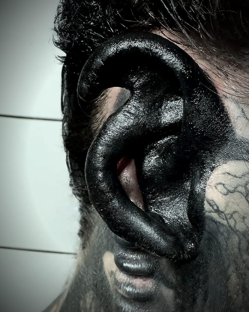 My modified ear, tattooed solid black